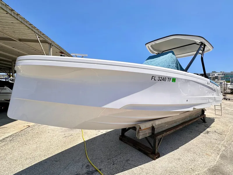 Slide: The Image of 2022 Axopar 22 T-Top boat on display, white hull, outdoor setting. - 3