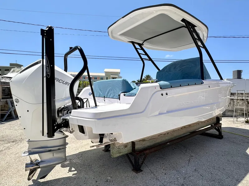 Slide: The Image of 2022 Axopar 22 T-Top boat with outboard motor, displayed outdoors. - 7