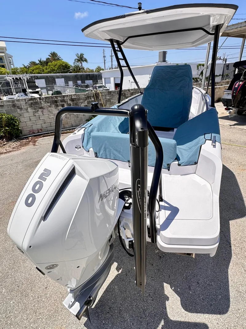 Slide: The Image of 2022 Axopar 22 T-Top boat with Mercury 200 engine, docked outdoors. - 8