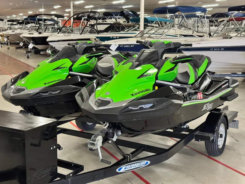 Slide: The Image of 2023 Kawasaki Jetski Ultra 310LX-S models on a trailer in a showroom. - 1