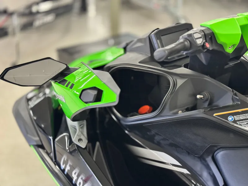 Slide: The Image of 2023 Kawasaki Jetski Ultra 310LX-S, green and black, close-up of handlebars and controls. - 12