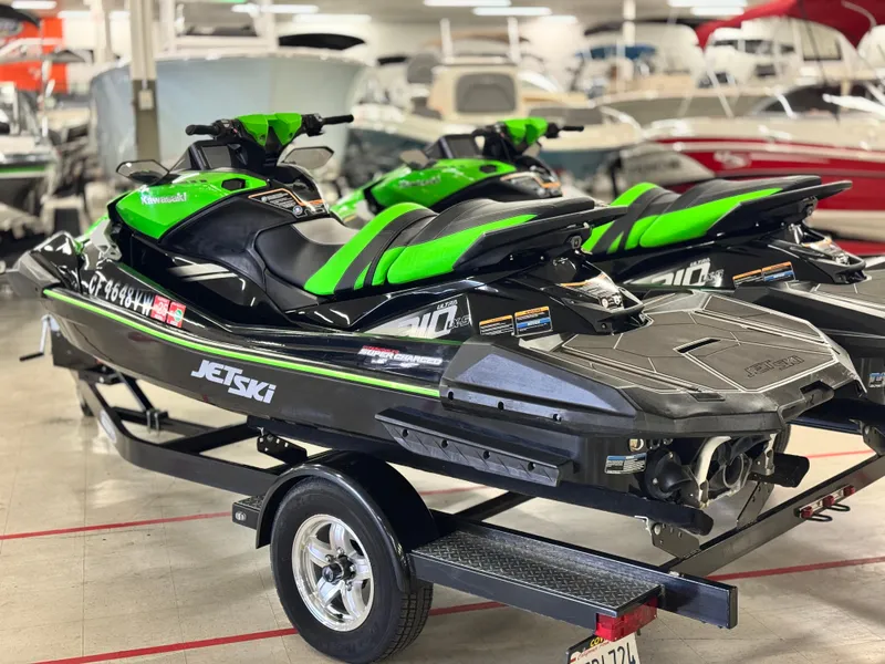 Slide: The Image of 2023 Kawasaki Jetski Ultra 310LX-S in showroom, vibrant green and black design. - 3