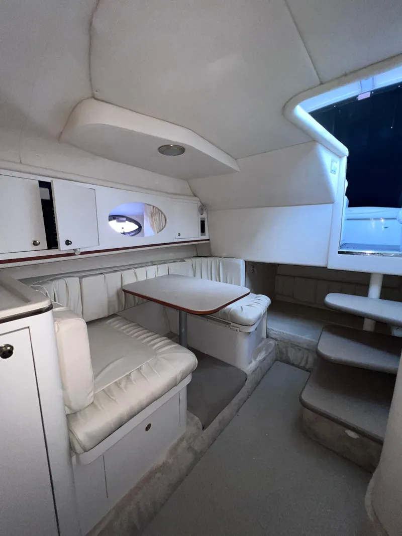Slide: The Image of Interior of 2000 Sea Ray 290 Amberjack boat with seating and storage. - 13