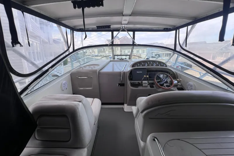 Slide: The Image of Interior view of 2000 Sea Ray 290 Amberjack boat cockpit with steering wheel and seating. - 6