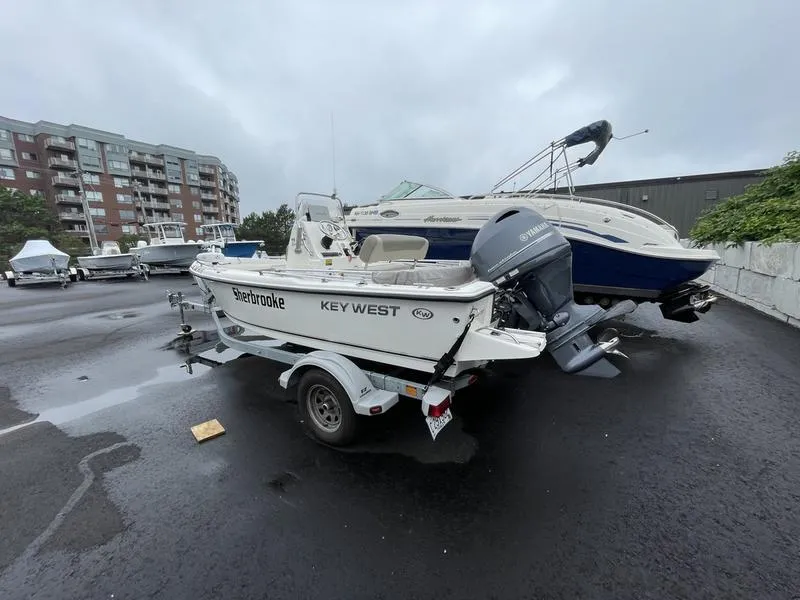 Slide: The Image of 2023 Key West 1720 CC boat on trailer in marina parking lot. - 5