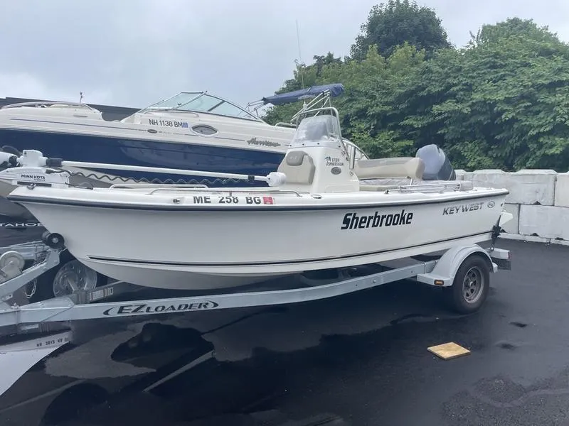 Slide: The Image of 2023 Key West 1720 CC boat on trailer, parked outdoors, labeled "Sherbrooke." - 6