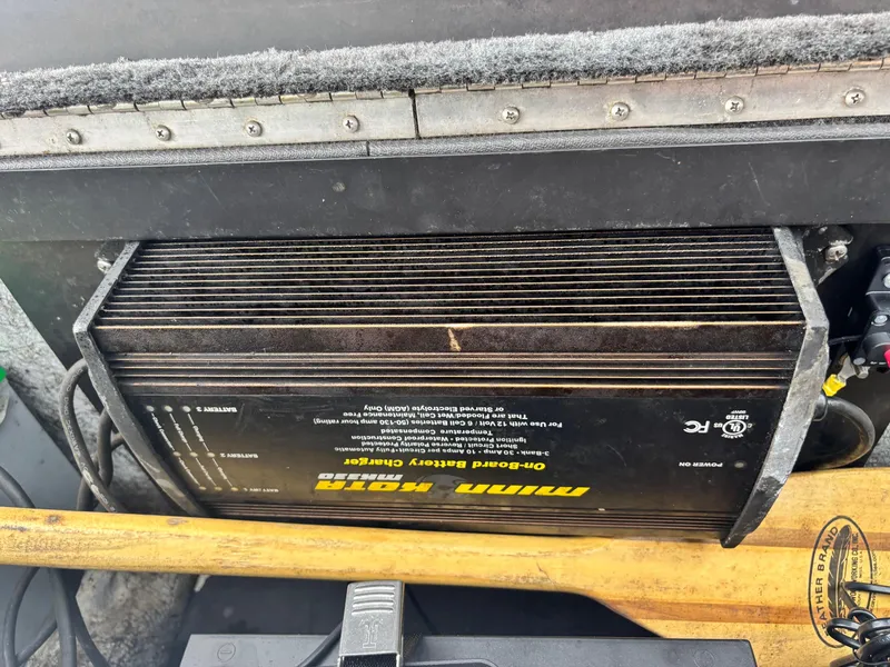 Slide: The Image of On-board battery charger in a 1999 Triton TR19 boat, featuring Minn Kota branding. - 13