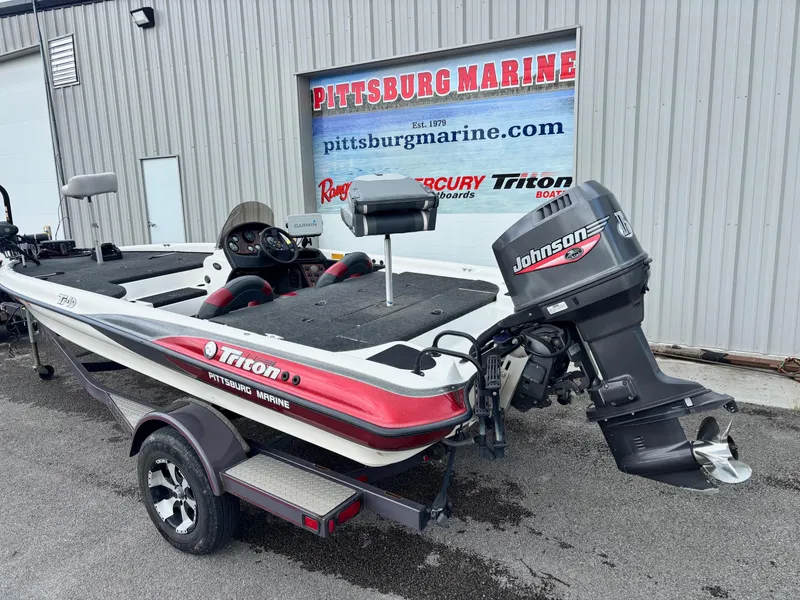 Slide: The Image of 1999 Triton TR19 boat with Johnson outboard motor at Pittsburg Marine dealership. - 14