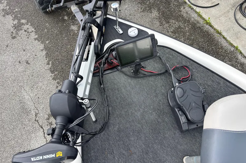 Slide: The Image of 1999 Triton TR19 boat deck with trolling motor and fish finder. - 2