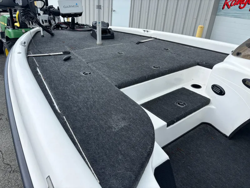 Slide: The Image of 1999 Triton TR19 boat deck with carpeted surface and Garmin equipment. - 6