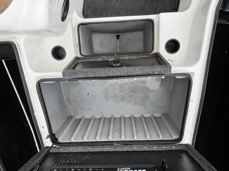 Slide: The Image of Open storage compartments in a 1999 Triton TR19 boat. - 8
