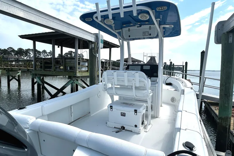 Slide: The Image of 2017 Sea Hunt Ultra 235 SE boat docked, featuring spacious seating and modern design. - 10