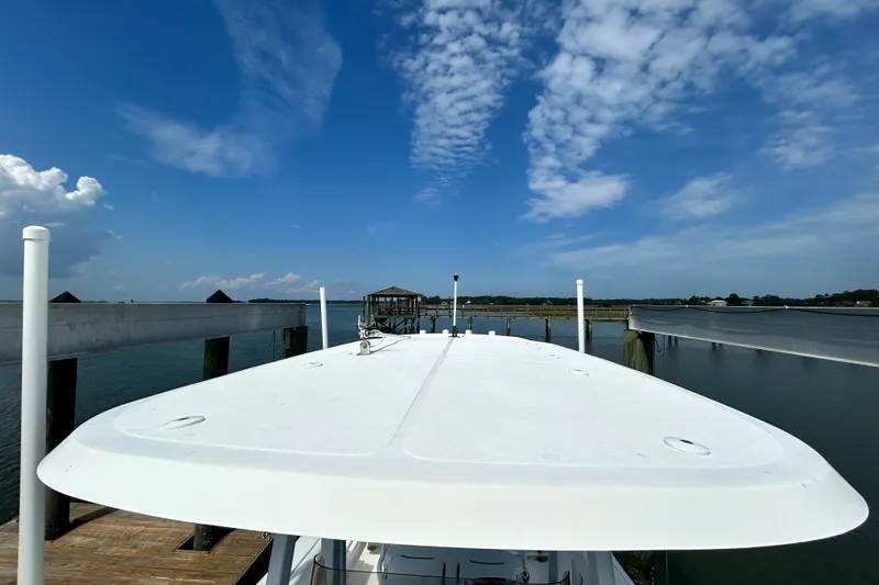 Slide: The Image of 2017 Sea Hunt Ultra 235 SE boat docked under a clear blue sky. - 15