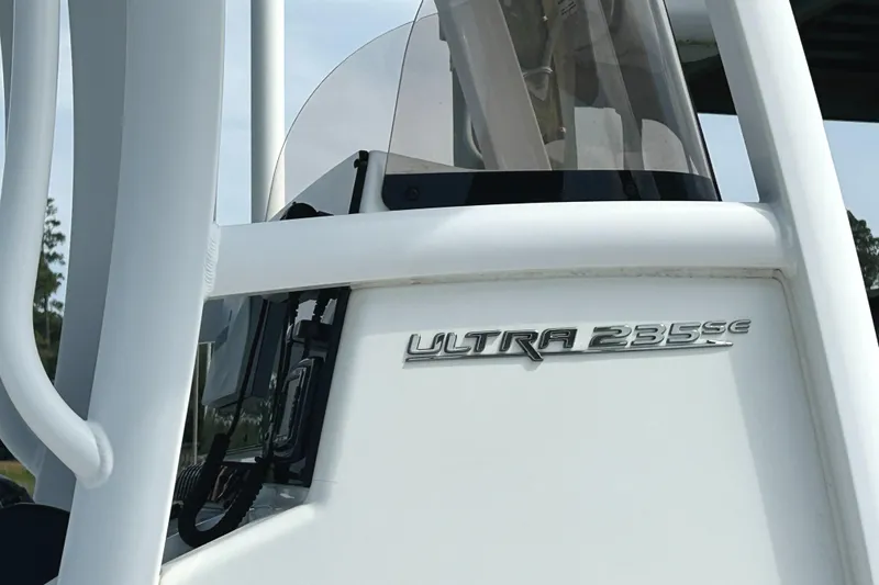 Slide: The Image of 2017 Sea Hunt Ultra 235 SE boat, close-up of model name on white exterior. - 18