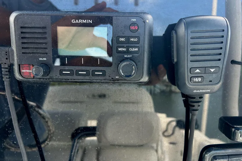 Slide: The Image of Garmin marine radio and microphone on 2017 Sea Hunt Ultra 235 SE boat dashboard. - 22