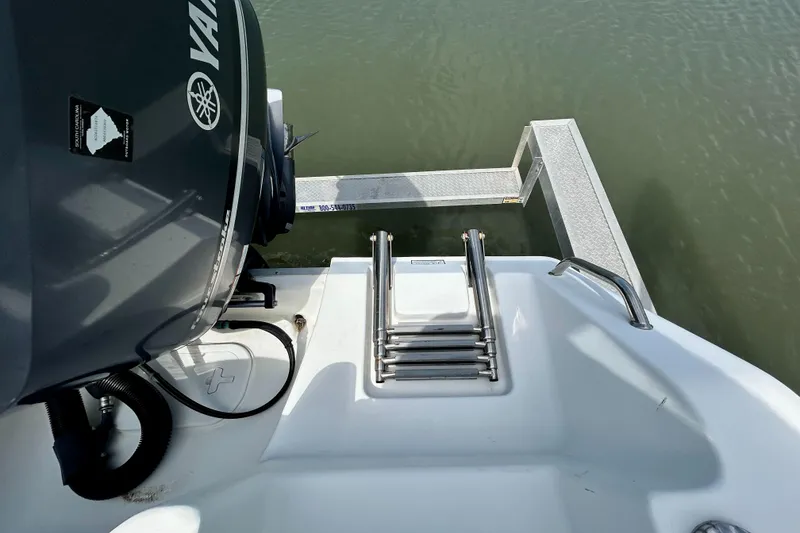 Slide: The Image of 2017 Sea Hunt Ultra 235 SE boat with Yamaha engine and swim ladder. - 23