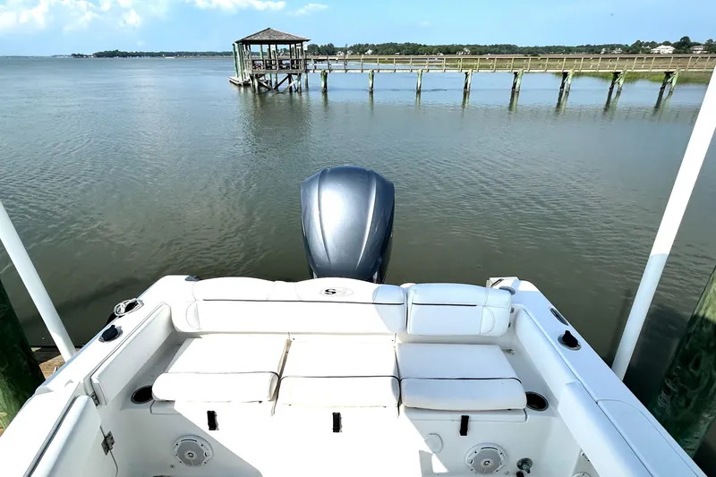 Slide: The Image of 2017 Sea Hunt Ultra 235 SE boat with scenic dock view. - 8