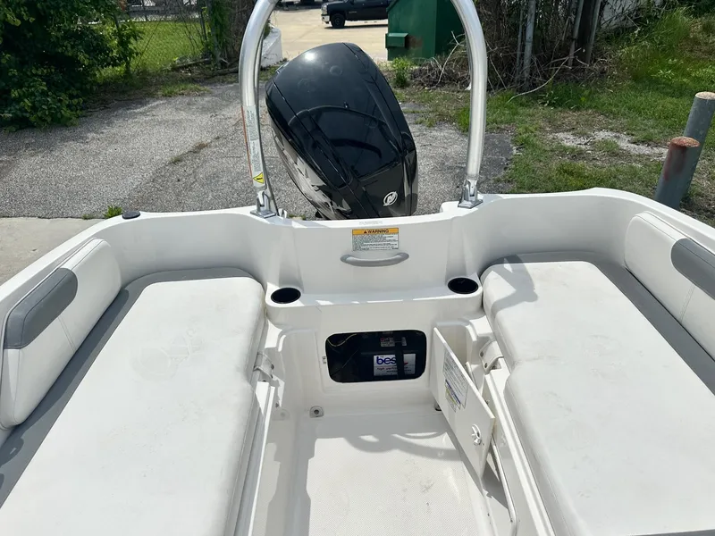 Slide: The Image of 2015 Bayliner Element E180 boat interior with seating and storage compartments. - 14