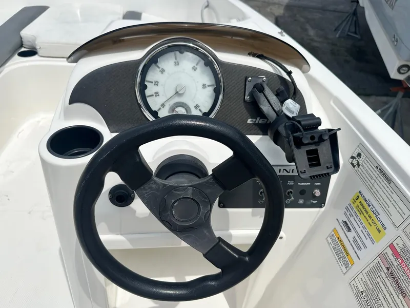 Slide: The Image of Steering console of 2015 Bayliner Element E180 boat with gauges and controls. - 16