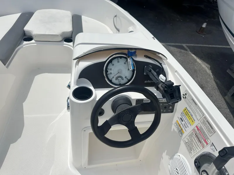 Slide: The Image of 2015 Bayliner Element 180 XL boat dashboard with steering wheel and gauges. - 17