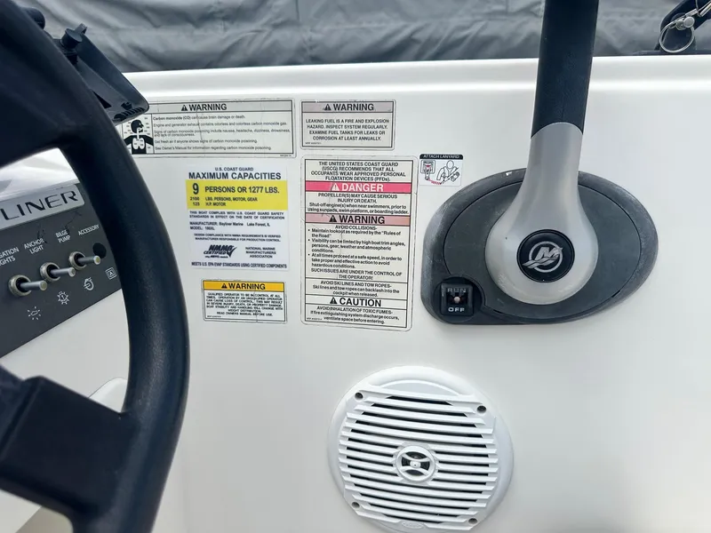 Slide: The Image of Control panel of 2015 Bayliner Element 180 XL boat with warning labels and speaker. - 19