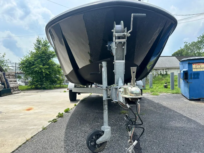 Slide: The Image of 2015 Bayliner Element E180 boat on trailer, parked outdoors. - 2