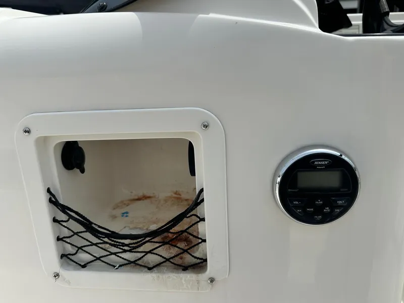 Slide: The Image of Storage compartment and control panel on 2015 Bayliner Element E180 boat. - 22