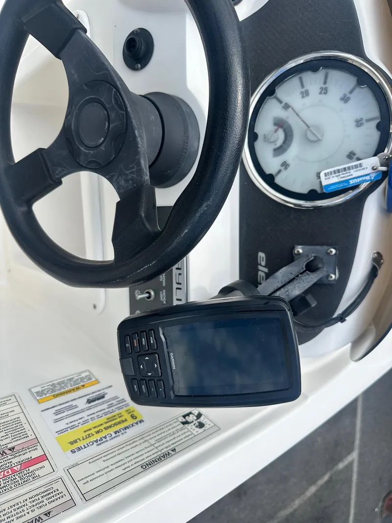 Slide: The Image of 2015 Bayliner Element 180 XL dashboard with steering wheel and gauges. - 23