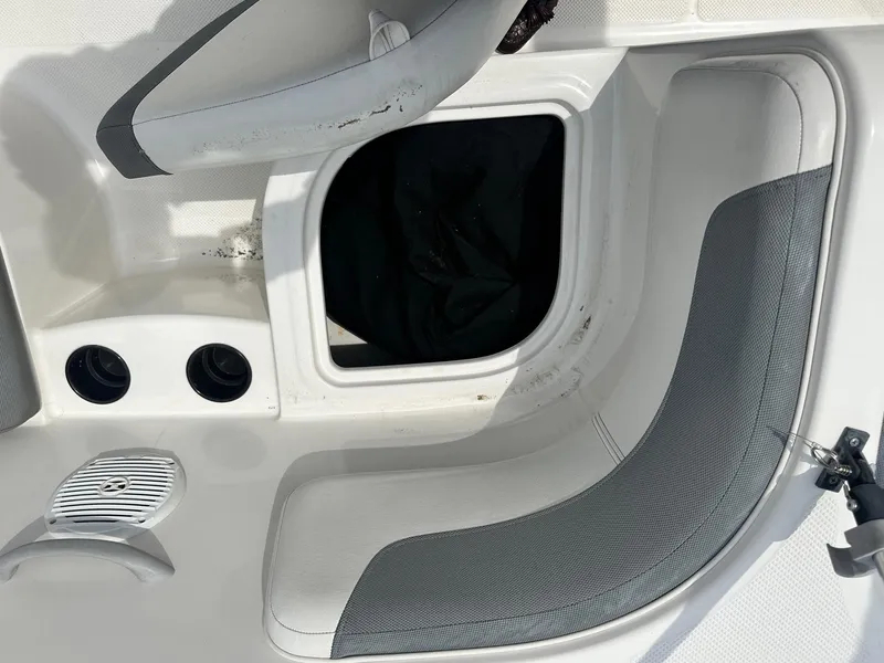 Slide: The Image of 2015 Bayliner Element E180 boat interior with storage compartment and seating. - 25