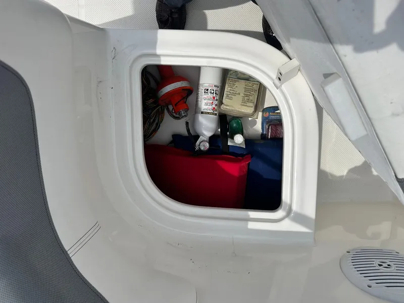 Slide: The Image of Storage compartment in a 2015 Bayliner Element E180 boat with safety equipment. - 26