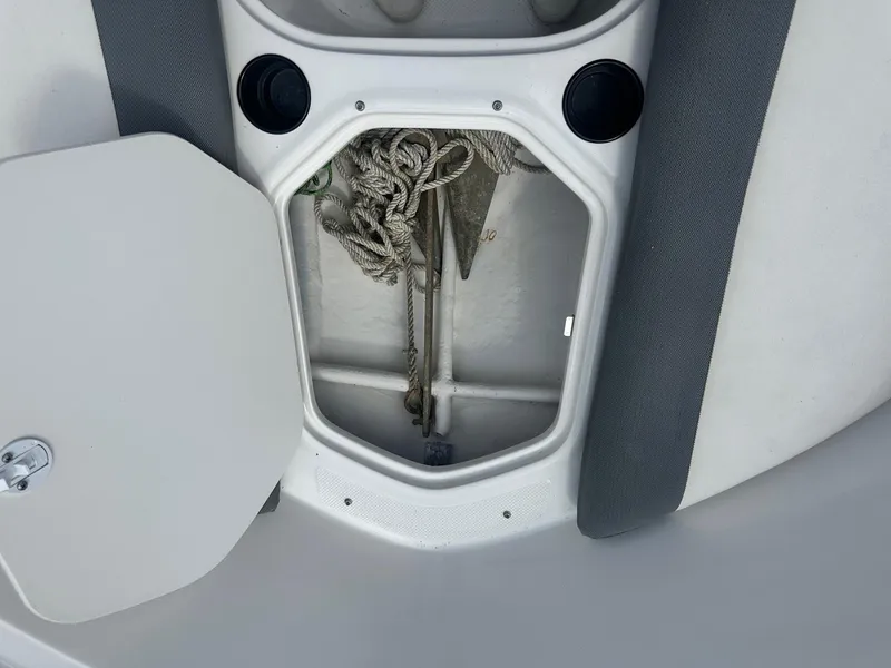 Slide: The Image of Open storage compartment on 2015 Bayliner Element 180 XL boat, showing ropes and anchor. - 29