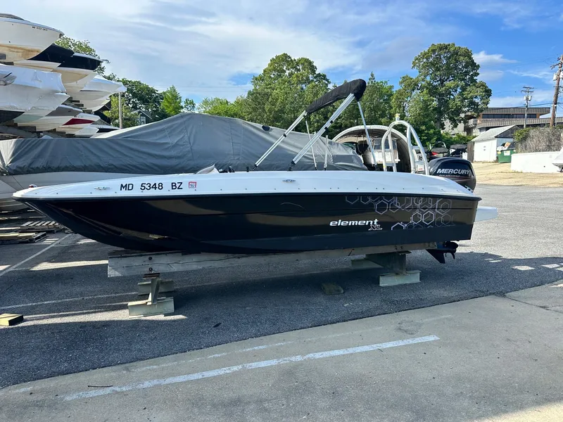 Slide: The Image of 2015 Bayliner Element 180 XL boat on display in a parking area. - 3