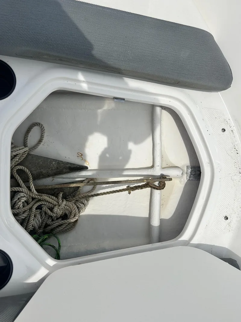 Slide: The Image of 2015 Bayliner Element E180 boat storage compartment with ropes and anchor. - 30