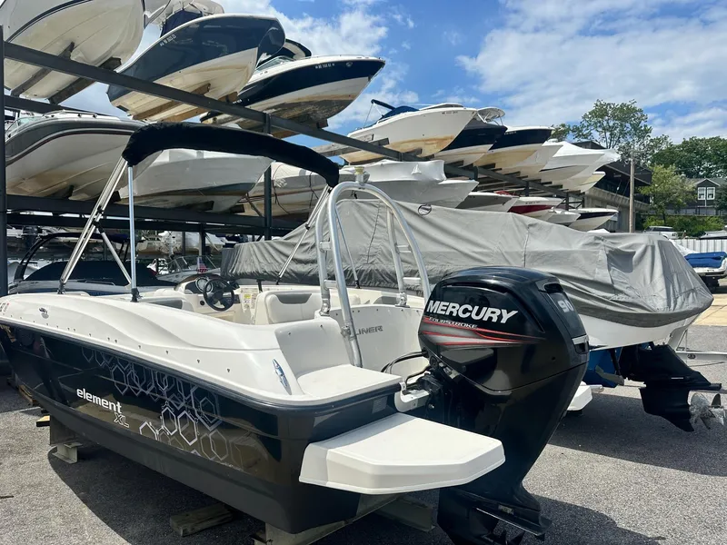 Slide: The Image of 2015 Bayliner Element 180 XL boat with Mercury engine in a marina storage area. - 5