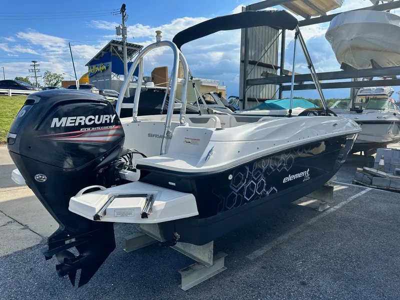 Slide: The Image of 2015 Bayliner Element 180 XL boat with Mercury outboard motor, docked outdoors. - 6