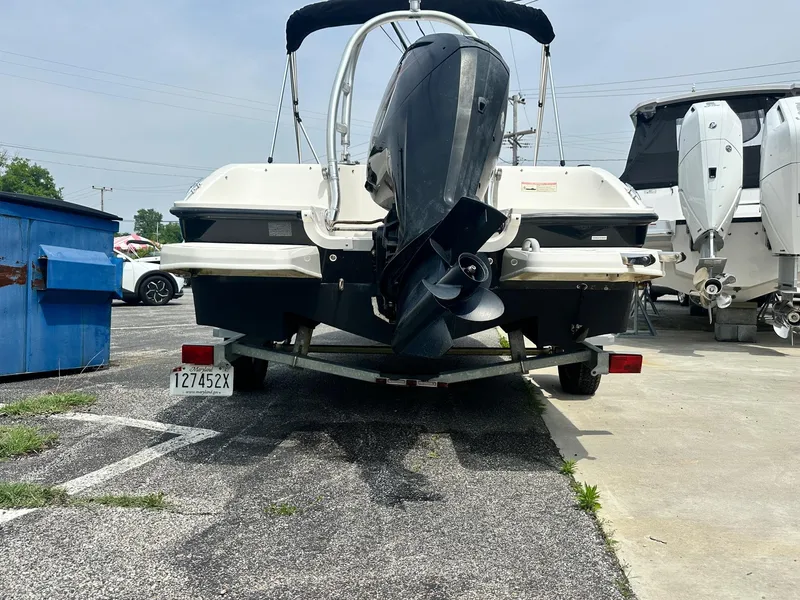 Slide: The Image of 2015 Bayliner Element E180 boat on trailer, rear view, parked outdoors. - 7