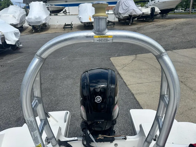 Slide: The Image of 2015 Bayliner Element 180 XL boat with motor, parked in a marina. - 9