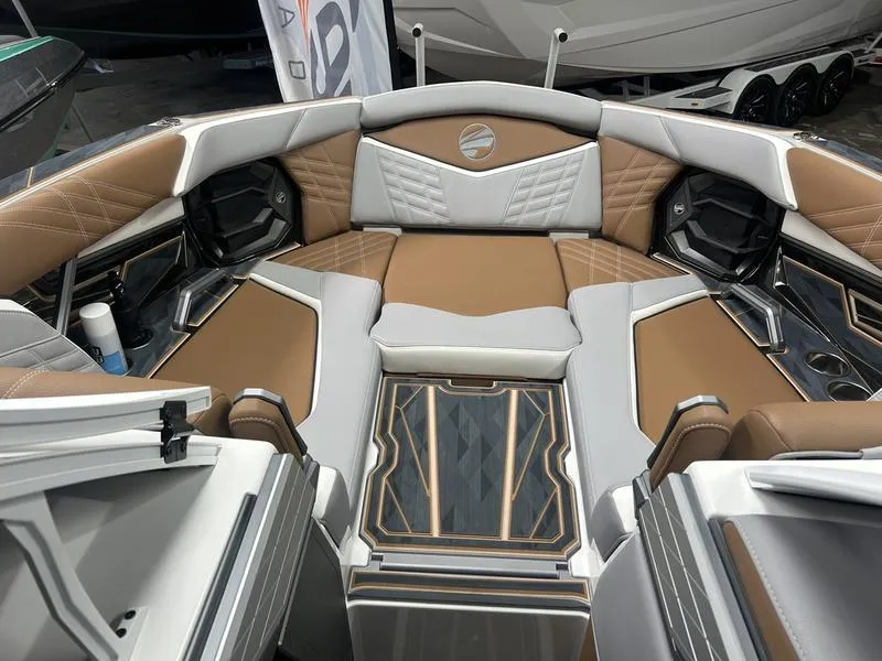 Slide: The Image of Luxurious interior of 2025 Tigé Ultré 23ZX boat with brown and gray seating. - 7
