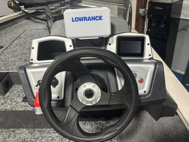 Slide: The Image of 2025 Tracker PT 175 TXW boat dashboard with Lowrance navigation system and steering wheel. - 7