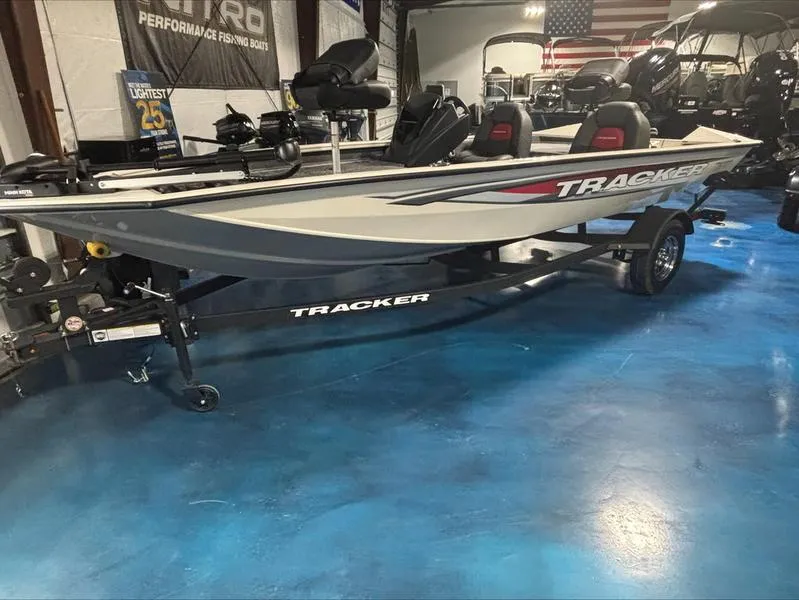 Slide: The Image of 2025 Tracker PT 175 TXW boat on display in showroom with blue floor. - 9