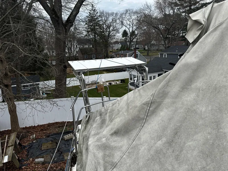 Slide: The Image of 1984 Catalina 36 Tall Rig sailboat covered, in a residential backyard setting. - 14