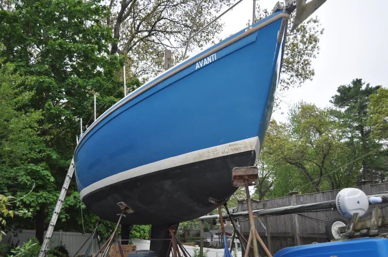 Slide: The Image of 1984 Catalina 36 Tall Rig sailboat on stands, blue hull, outdoor setting. - 3