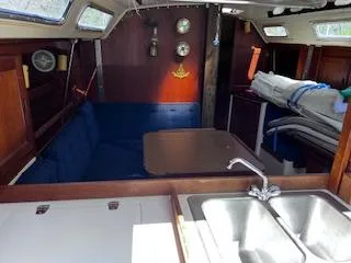Slide: The Image of Interior of 1984 Catalina 36 Tall Rig sailboat with cozy seating and kitchen area. - 5