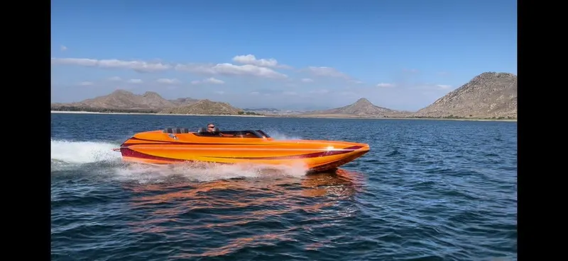 Slide: The Image of 2025 Essex Boats CR22 speeding on a lake with mountainous backdrop. - 3