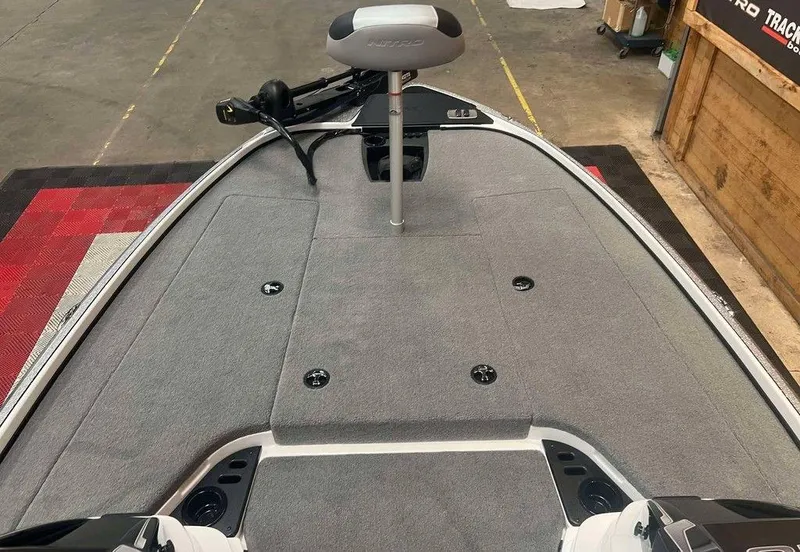 Slide: The Image of 2025 Nitro Z18 boat deck with gray carpet and seating. - 6