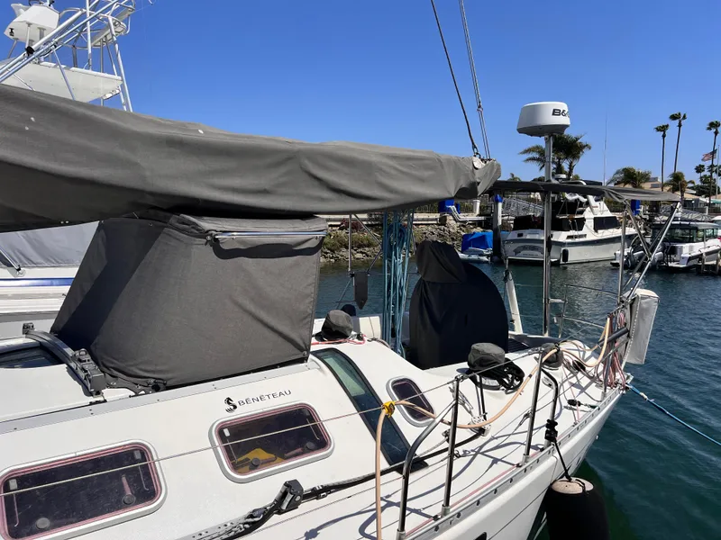 Slide: The Image of Sailboat Beneteau First 41s5, 1990 model, docked in a sunny marina. - 10
