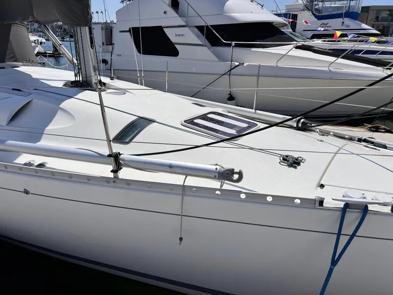 Slide: The Image of Sailboat Beneteau First 41s5, 1990 model, docked at marina with other boats. - 14