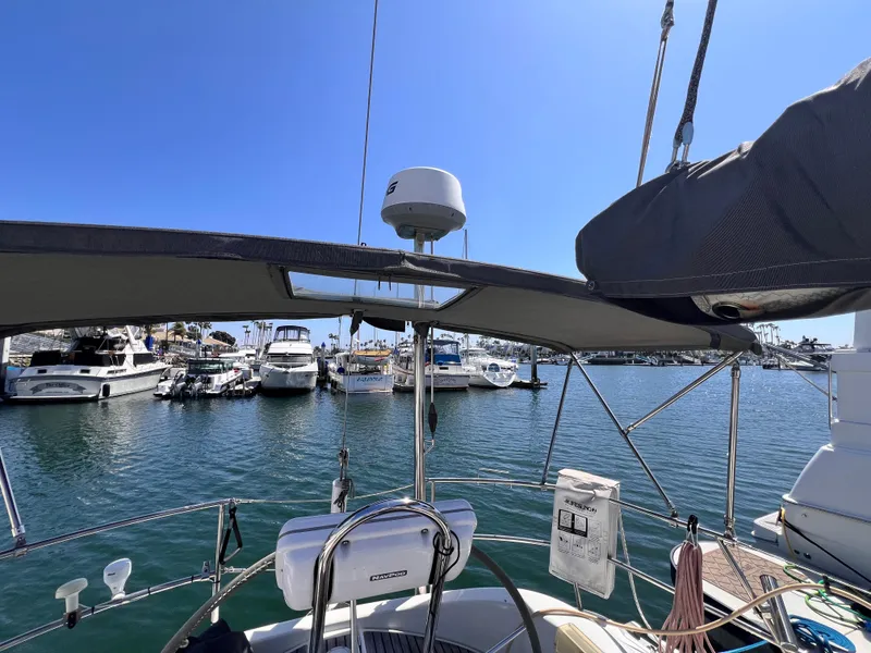 Slide: The Image of Sailboat cockpit view of 1990 Beneteau First 41s5 in marina, clear blue sky. - 24