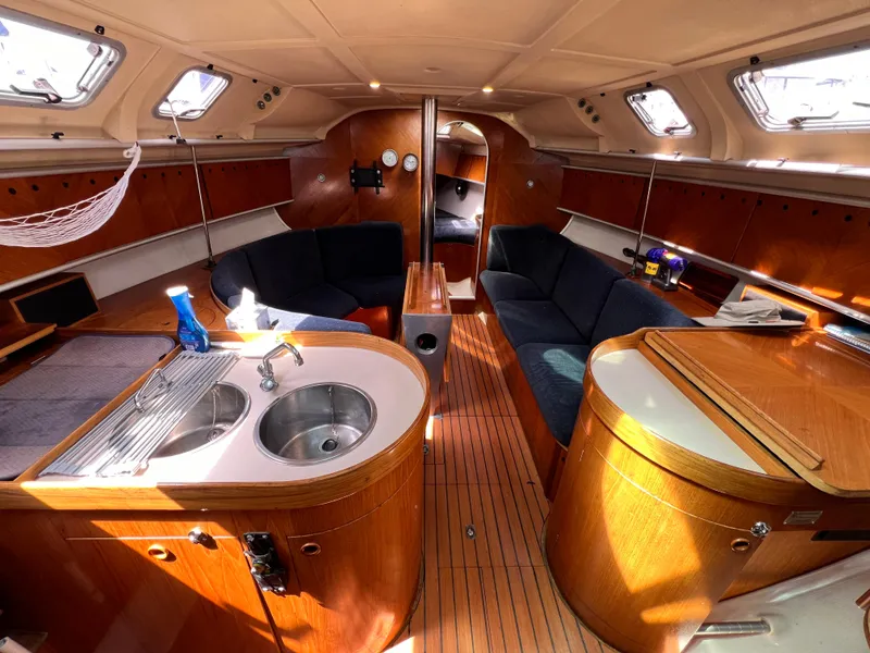 Slide: The Image of Interior of 1990 Beneteau First 41s5 sailboat with wood finish and modern amenities. - 26