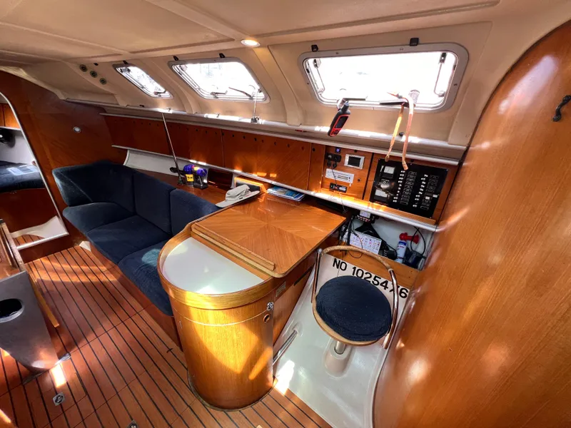 Slide: The Image of Interior of 1990 Beneteau First 41s5 sailboat with wood finish and seating area. - 27